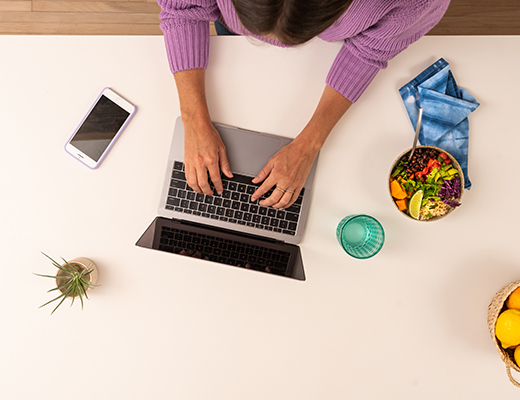 Woman using her laptop to access Zelle.